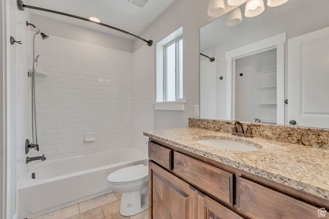 Primary private bath with granite counter tops tile surround shower. | Image 9