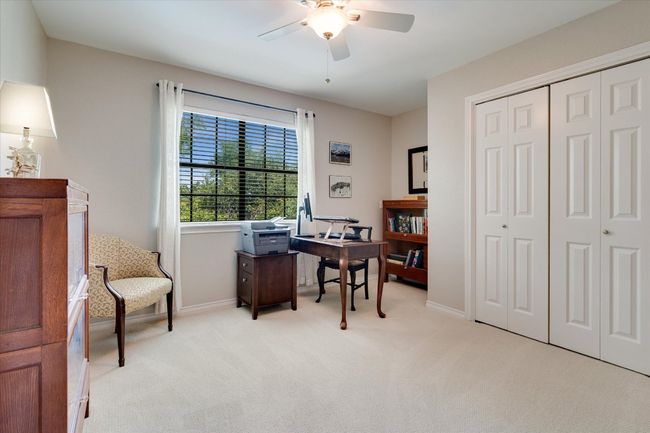 Bedroom or Office with light colored carpet, a ceiling fan, and baseboards | Image 26