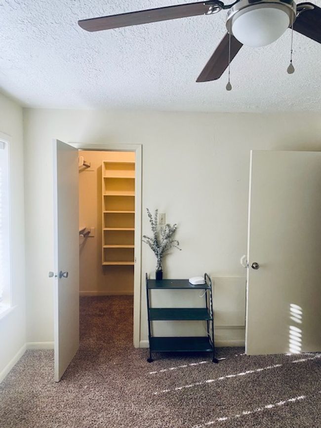 Hall featuring a textured ceiling, carpet floors, and baseboards | Image 13