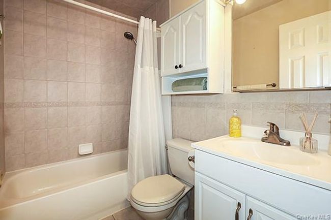 Bright bathroom with storage cabinets | Image 19