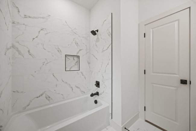 Full bath featuring shower / bathtub combination, baseboards, and marble finish floors | Image 26