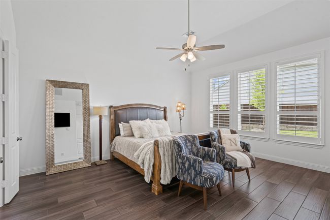 Bedroom featuring dark wood-type flooring, baseboards, and ceiling fan | Image 22