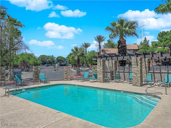 Community pool with fence, a patio area, and a pergola | Image 18