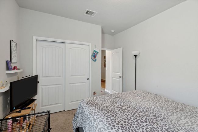 Bedroom featuring light carpet and a closet | Image 14
