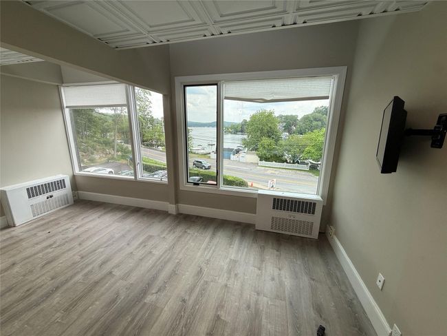 Unfurnished sunroom with an AC wall unit | Image 4