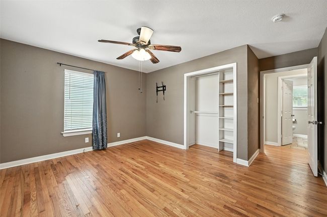 Unfurnished bedroom featuring wood finished floors and ceiling fan | Image 19