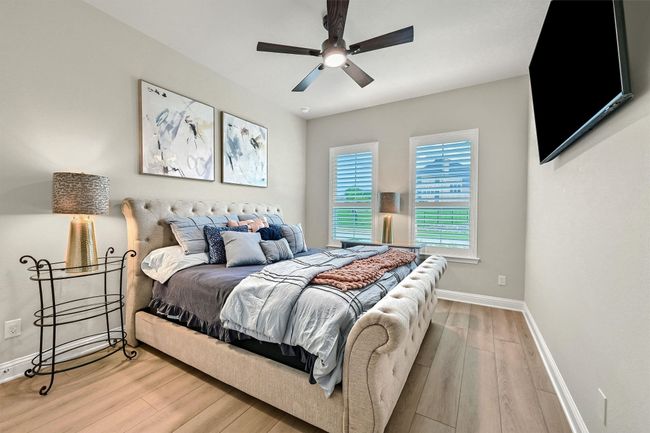 Bedroom with wood finished floors, baseboards, and ceiling fan | Image 24