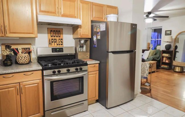 Kitchen featuring ceiling fan, light tile patterned flooring, and appliances with stainless steel finishes | Image 9