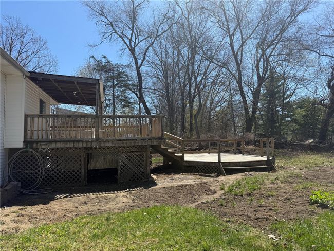 Covered porch and 1st deck View of yard featuring a wooden deck and stairway | Image 21