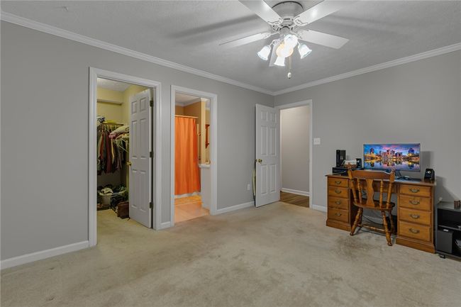 Photo of the master bedroom en-suite. Again the sellers have removed most of the furniture preparing for their move. You can see from here the master bath and large walk-in closet. Plenty of room for you bedroom furniture | Image 10