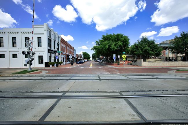 View of street with curbs, sidewalks, street lights, traffic signs, and a residential view | Image 34