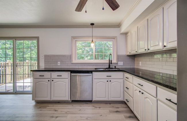 Kitchen offers plenty of counter space for cooking and window overlooking lush trees. | Image 15