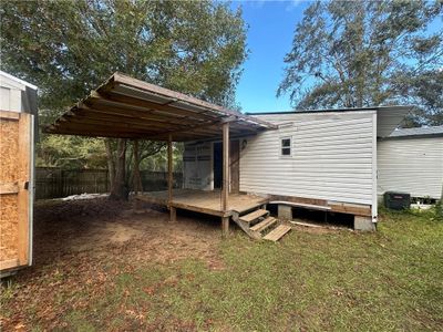 Rear view of property featuring central AC and a yard | Image 2