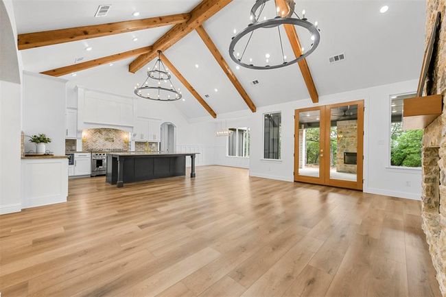 Living room with beamed ceiling, high vaulted ceiling, and light hardwood / wood-style floors | Image 8