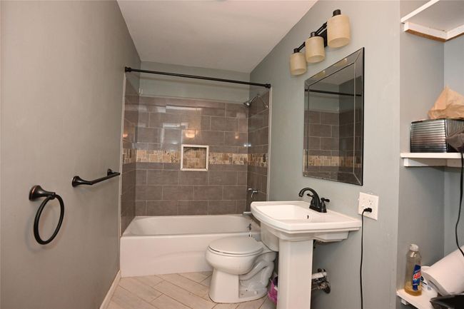 Hall Bathroom featuring tiled shower / bath combo and toilet | Image 22