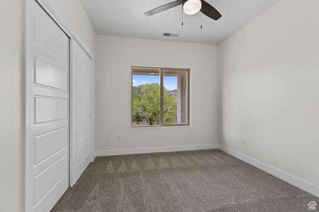 Unfurnished bedroom featuring baseboards, carpet floors, visible vents, and a ceiling fan | Image 18