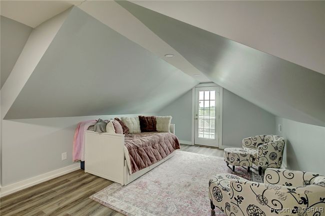 Bedroom with access to outside, light hardwood / wood-style flooring, and vaulted ceiling | Image 50