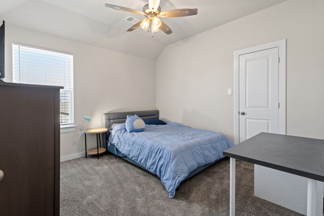 Bedroom featuring visible vents, baseboards, carpet, vaulted ceiling, and a ceiling fan | Image 19