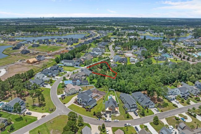 Aerial view of property's location featuring a large body of water, nearby suburban area, and property parcel outlined | Image 9