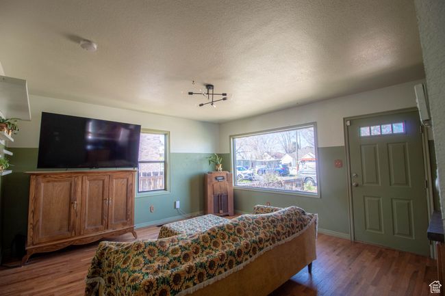 Bedroom featuring a textured ceiling, wood finished floors, and baseboards | Image 9