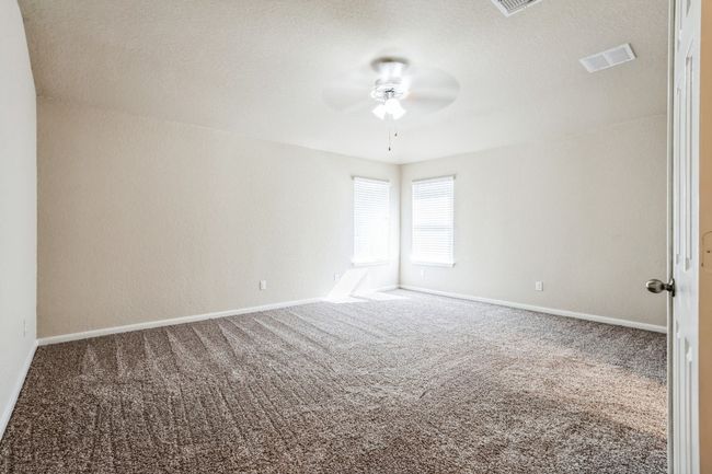 Carpeted spare room with ceiling fan | Image 10