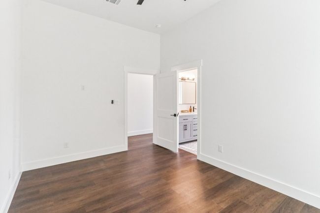 Empty room with dark wood-type flooring and ceiling fan | Image 14
