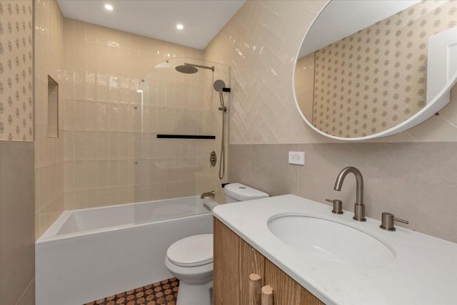 Bathroom featuring vanity, shower / bath combination, tile walls, and recessed lighting | Image 15