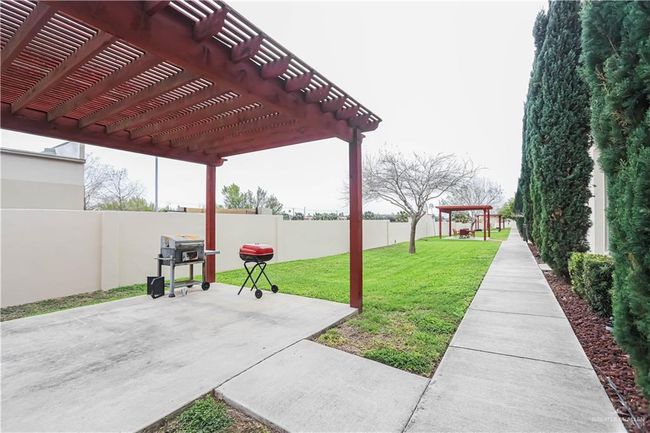 View of patio featuring a fenced backyard and a pergola | Image 23