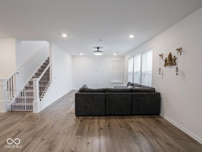 unfurnished living room featuring recessed lighting, stairs, baseboards, and wood finished floors | Image 13