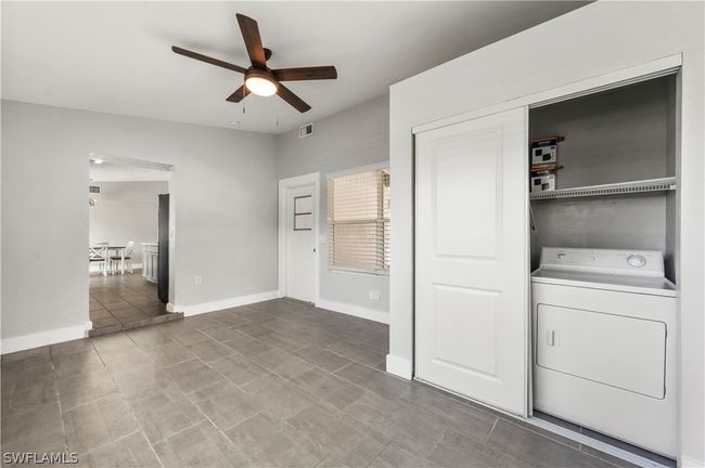Clothes washing area featuring tile patterned floors, washer / dryer, and ceiling fan | Image 36