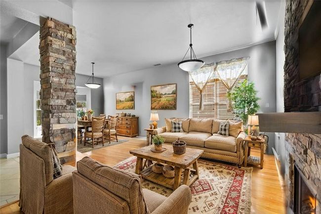 Open living room with stone fireplace - virtually​​‌​​​​‌​​‌‌​‌‌​​​‌‌​​‌‌​‌​​​​​‌ staged | Image 4