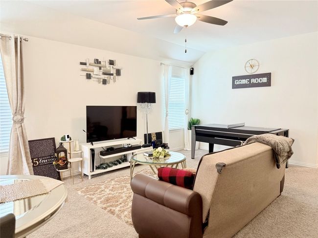 Living room featuring ceiling fan, vaulted ceiling, and carpet | Image 26