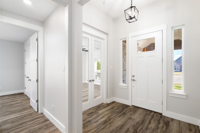 Entrance foyer with dark hardwood / wood-style flooring and a notable chandelier | Image 6