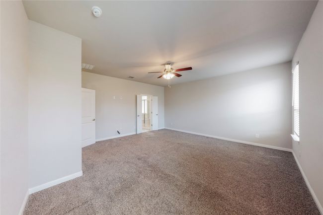 Carpeted spare room with ceiling fan, baseboards, and a smoke detector | Image 17