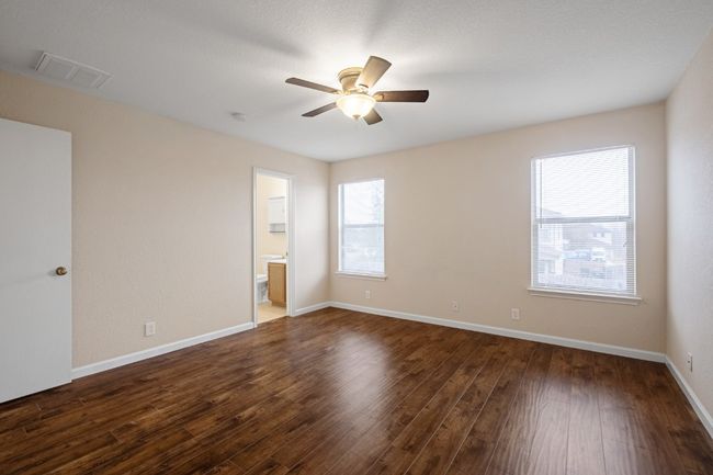 Unfurnished room featuring a ceiling fan, dark wood-type flooring, and a smoke detector | Image 22