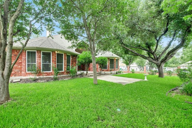 Rear view of property with a yard, brick siding, and roof with shingles | Image 35