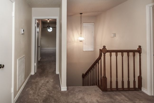 Stairs with carpet flooring and baseboards | Image 18