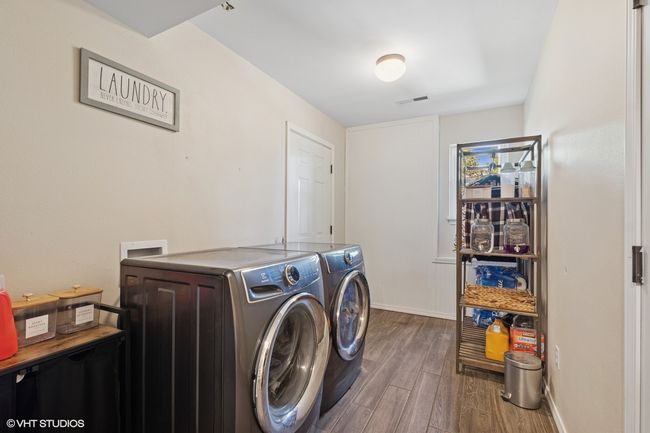 Laundry room featuring washing machine and dryer, wood finished floors, and baseboards | Image 30