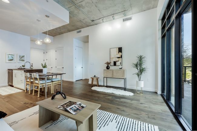 The concrete ceiling adds an edge to the room that makes everything else—art, lighting, even furniture—stand out more by contrast | Image 4