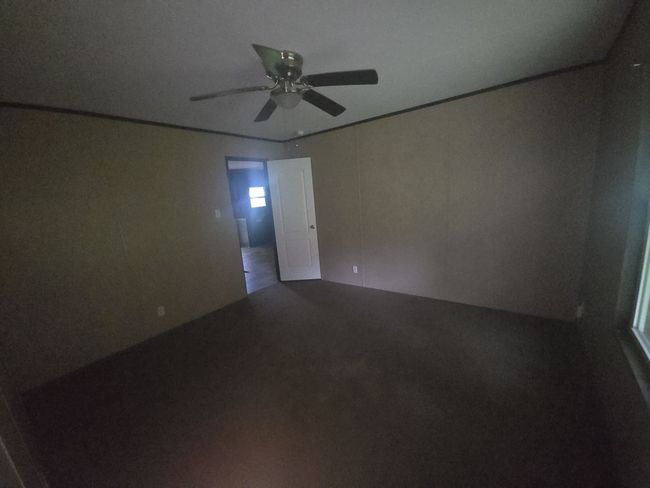 Unfurnished room featuring ceiling fan and carpet | Image 14