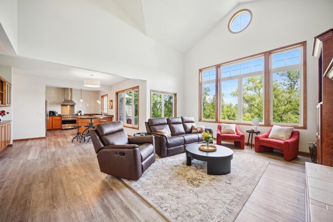 The main level features soaring vaulted ceilings and an abundance of windows that flood the space with natural light. | Image 8