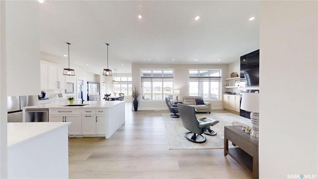 Kitchen with stainless steel dishwasher, light wood-style flooring, white cabinets, recessed lighting, and light countertops | Image 5