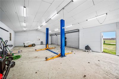 View of garage with car lift | Image 3