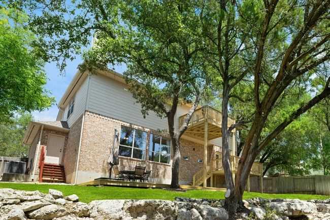 Surrounded by tall trees and backing to the greenbelt, the backyard feels quiet and undisturbed—like a pocket of nature hidden in the middle of the neighborhood *Virtual green grass | Image 31