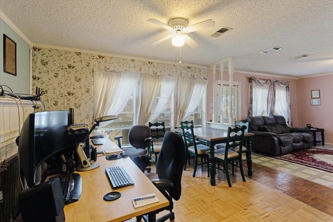 Dining area is open to living room. ornamental molding, and light parquet floors | Image 13