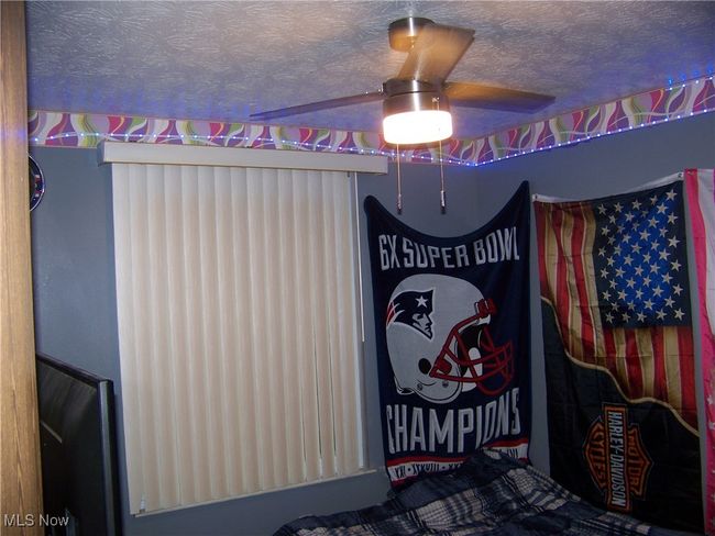 Bedroom featuring a textured ceiling and ceiling fan | Image 25