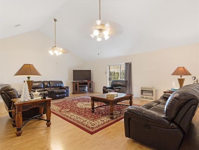 ...haslaminate flooring and high ceiling | Image 8