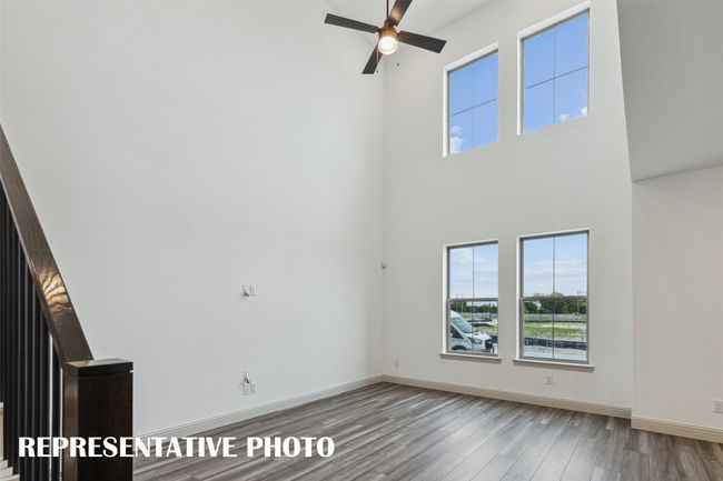 Featuring volume windows in the family room, this beautiful home is filled with natural light. REPRESENTATIVE PHOTO | Image 5