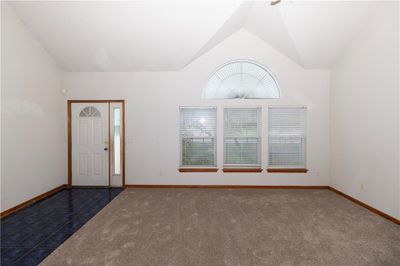 Tiled entryway featuring lofted ceiling | Image 3