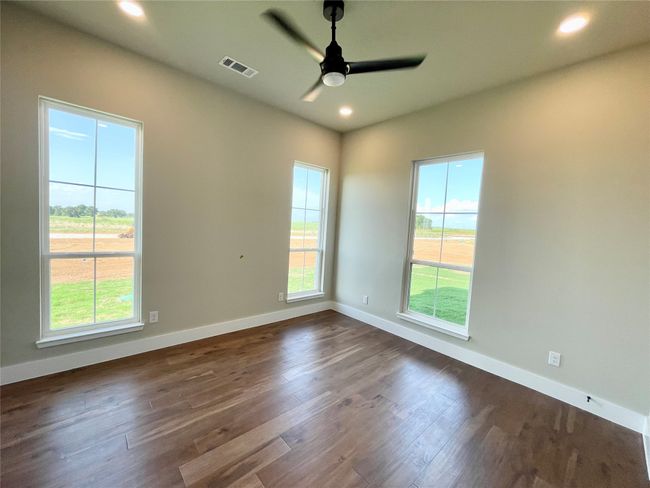 Secondary bedrooms are light and bright and feature recessed lighting and wood floors. | Image 25